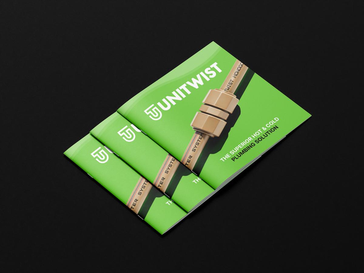 Unitwist handbook cover mockup featuring green branded plumbing brochures with push-fit pipe fittings on a black background.